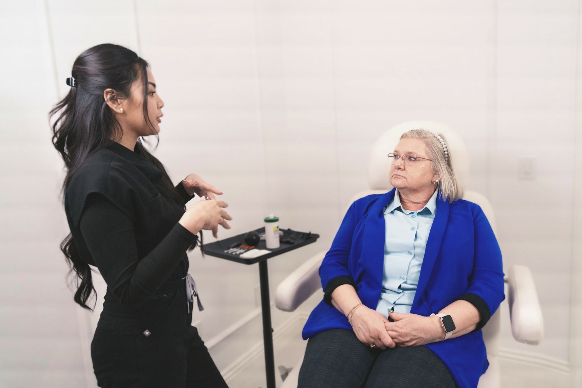 A clinician in consultation with a seated client